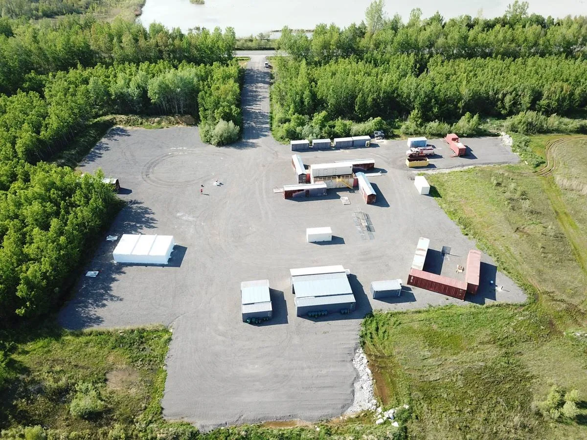 Aerial photograph of the Ottawa Fire Services Barnsdale Road training facility showing sea containers, tankers, and pumpers across the 36-hectare site
